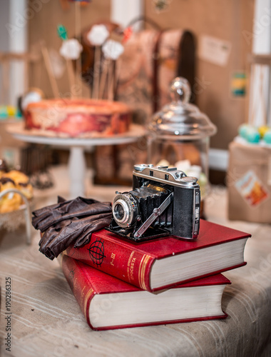 old vintage camera with old books on table