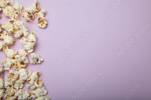 Popcorn on pink background. Copy space.