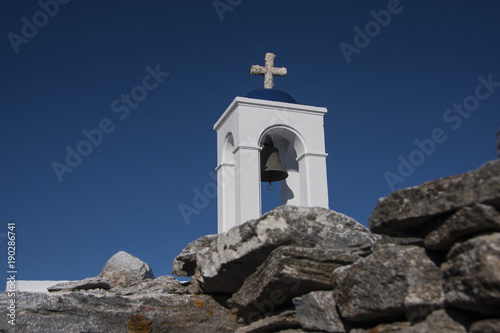 Bell and rocks, white cross