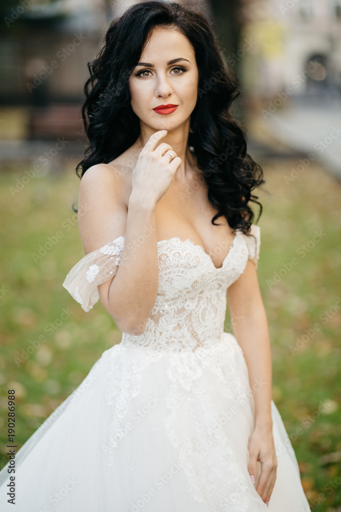 Beautiful bride in elegant white dress posing Beautiful bride in elegant white dress posing
