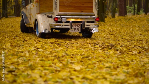 Custom truck creative idea with blue color artificial rust and wooden luggage retro cars in a fall forest photo