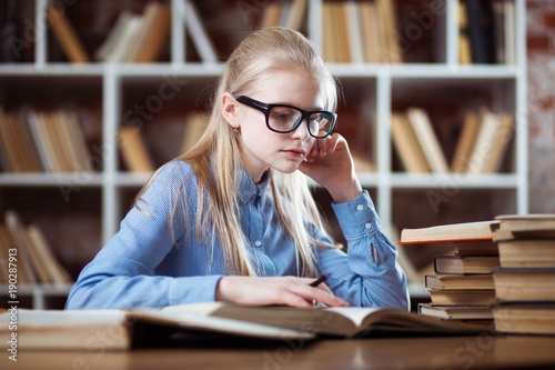 Teenage girl in a library © George Dolgikh