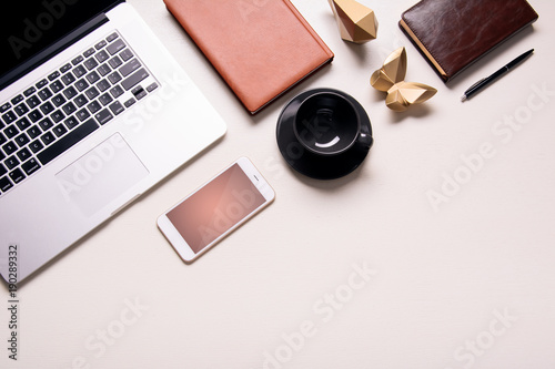 Business background with electronic devices like notebook or mobile phone. Workplace of CEO, chef director, manager or designer. Office flat lay to write words down. Modern informational technologies 