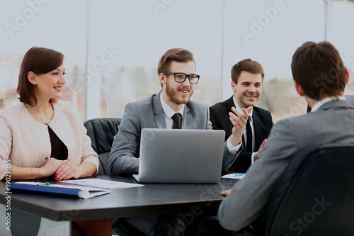 Group of business partners discussing ideas at meeting in office.