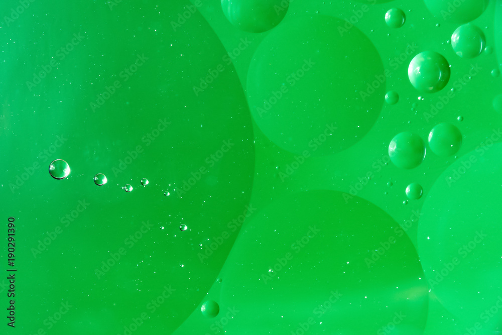 water and oil, beautiful color abstract background based on green circles and ovals, macro abstraction