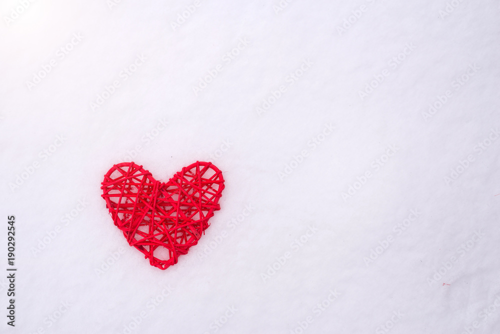 Concept for Valentine's Day, wedding: red heart on snow.
