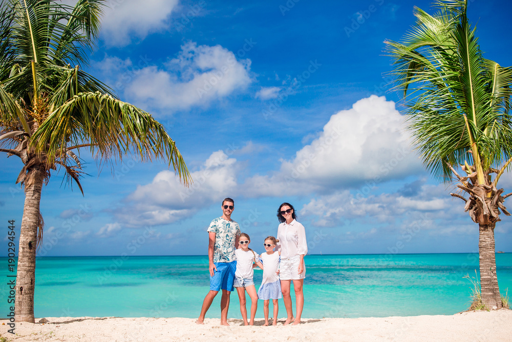 Family in white on the beach on caribbean vacation