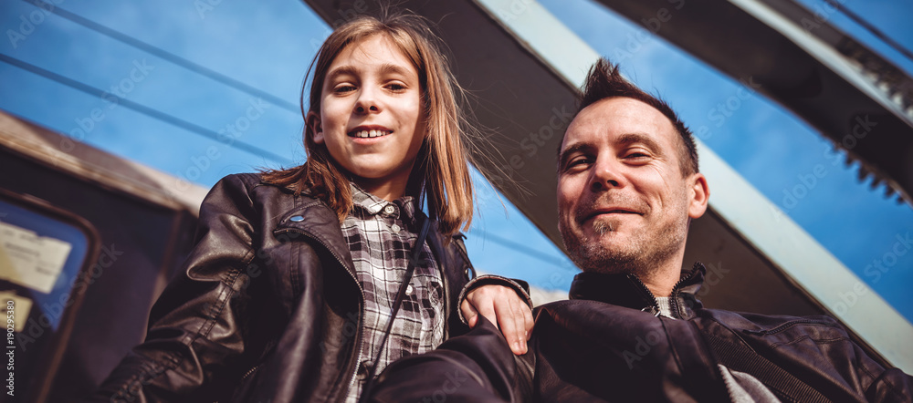 Father and daughter taking photos on the freight bridge Father and daughter taking photos on the freight bridge