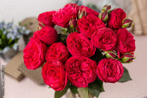 Fototapeta Naklejka Na Ścianę i Meble -  Red garden rose. Bouquet flowers of roses in glass vase. Shabby chic home decor.