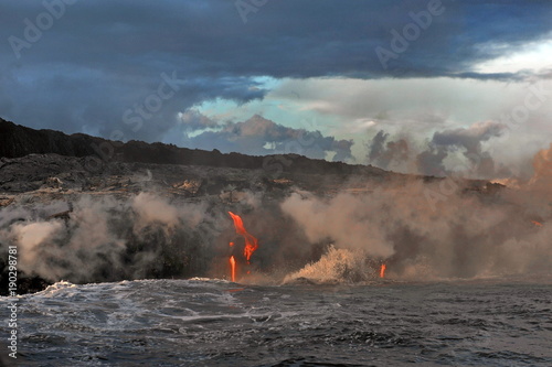 The hot lava of the Hawaiian volcano Kilauea flows into the waters of the Pacific Ocean