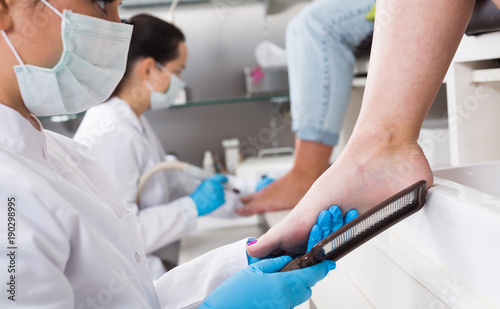 Nail master performing pedicure