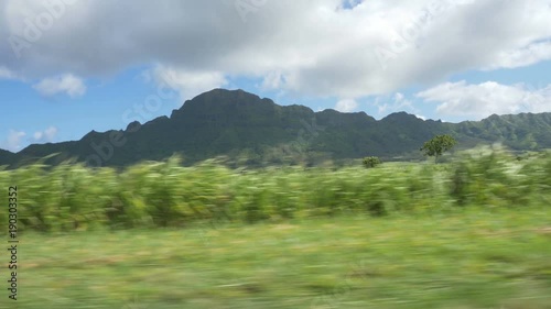 Side view driving POV towards the Haupu mountain range on Kauai, Hawaii. photo