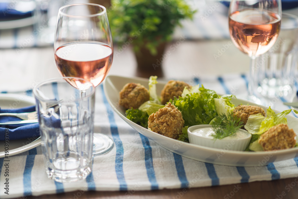 Restaurant table set with glasses, napkins and cutlery