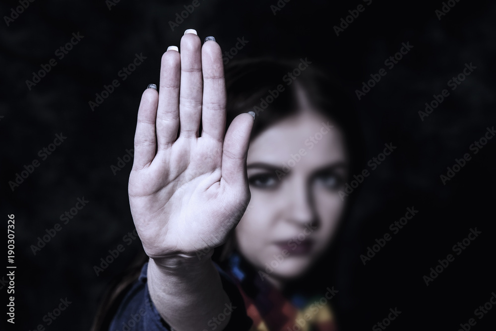 Girl showing stop hand sign gesture (Body language, gestures, psychology concept) Girl showing stop hand sign gesture (Body language, gestures, psychology concept)
