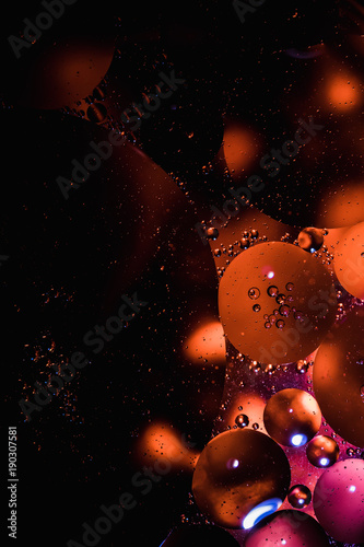 Abstract macro oil in water. I made this using a high powered falshlight and orange food coloring. That way there are hard shadows and bright circles to create a a unique look.