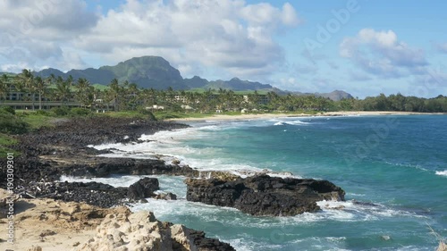 Panning view of Shipwreck Beach in Keoniloa Bay, Poipu, Kauai, Hawaii. photo