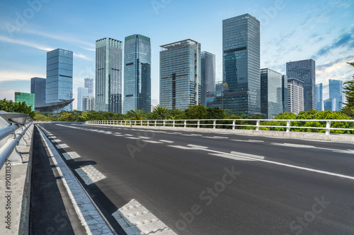 empty asphalt road on modern bridge with city skyline background. © hallojulie