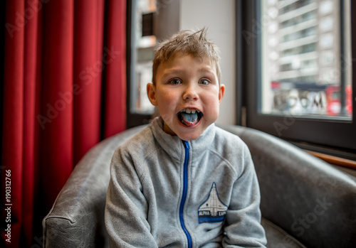 Boy having breakfast in the coffee shop in London photo