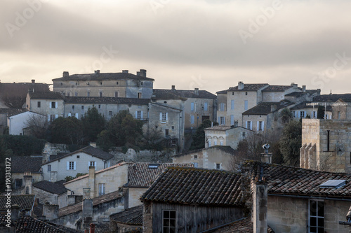 Panorama of the medieval city of Saint Emilion, France with the wineyards in background, during a sunny afternoon. Saint Emilion, famous for its Bordeaux wines, is one of the oldest cities of the area photo