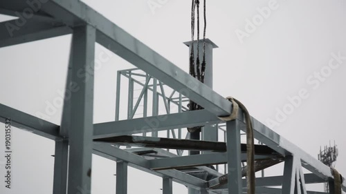 Crane is used in the construction of buildings. construction crane equipment over building construction site and take worker to high site on day. Construction site background photo