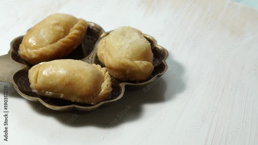 Gujiya, and Indian sweet made for the festival of Holi a festival of colors. Gujiya, and Indian sweet made for the festival of Holi a festival of colors.