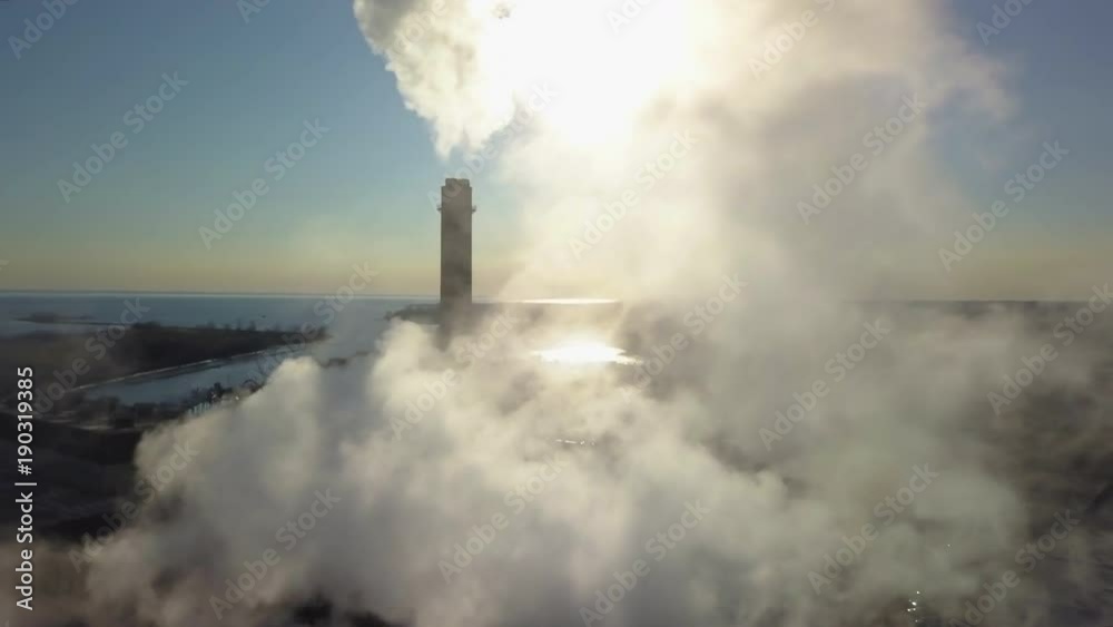 orbiting clockwise reveal of smoking smokestack orbiting clockwise reveal of smoking smokestack