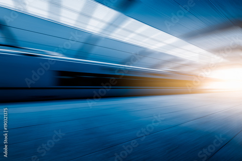 Subway station with train running in blurred motion