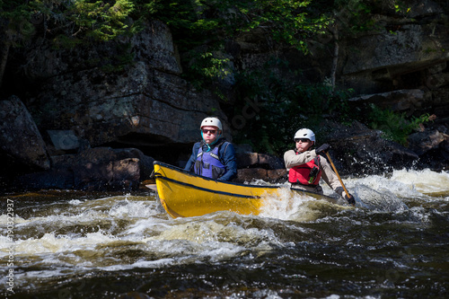 Group of people paddling the whitewater of the Noire River in Quebec, Canada.