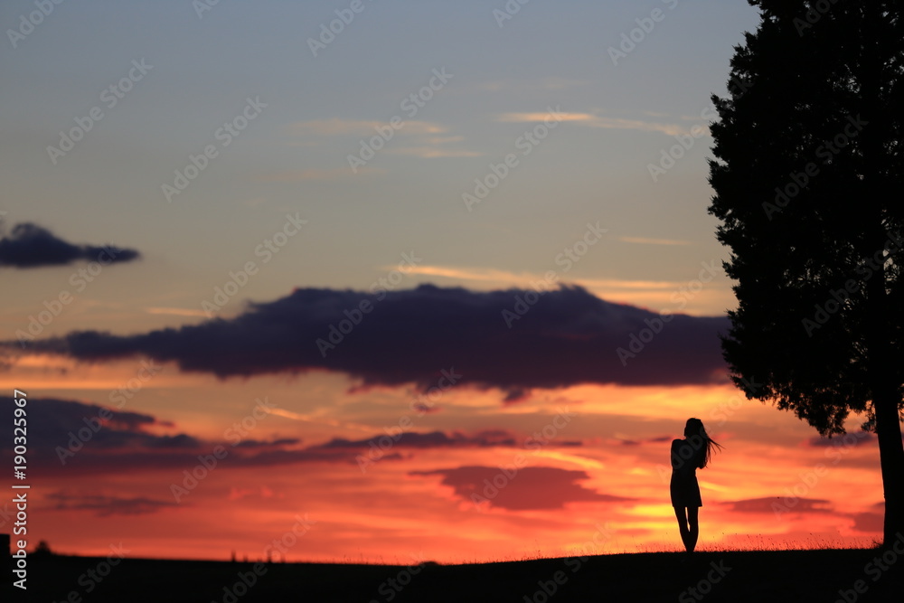 a silhouette under Tuscany sunset, Italy for summer time