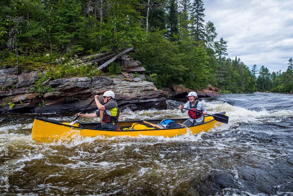 Group of people paddling the whitewater of the Noire River in Quebec, Canada.