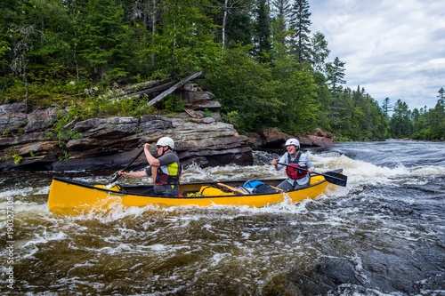 Group of people paddling the whitewater of the Noire River in Quebec, Canada.