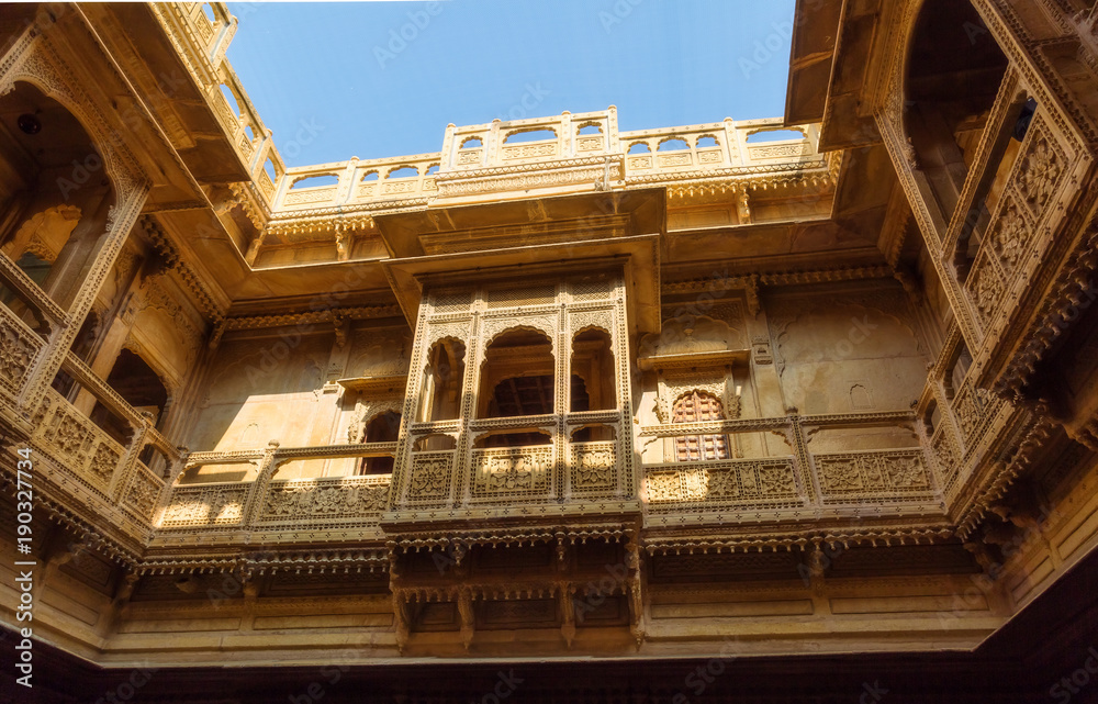 Rajasthan heritage building exterior made of yellow limestone known as the Patwon ki haveli at Jaisalmer.