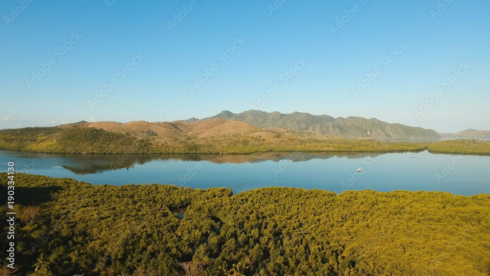 Tropical landscape, at sunrise time with mountains, tropical forest, bay, mangrove forest. Aerial view Seashore with jungle. Coron, Philippines,Palawan, Busuanga. Travel concept