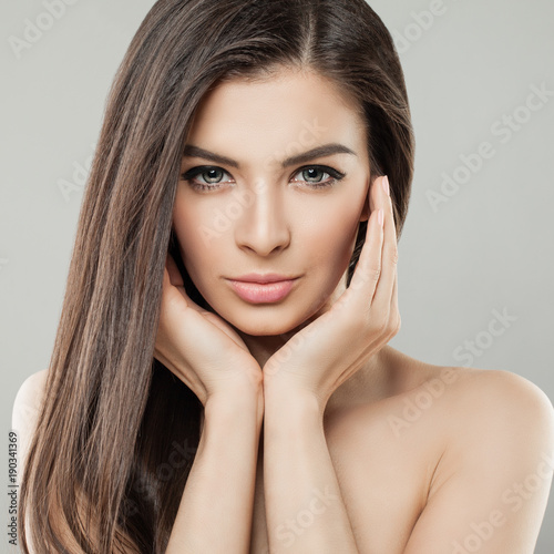 Young beautiful woman face close up portrait with healthy skin and hair
