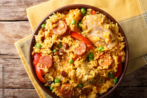 Arroz Valenciana with rabbit, chorizo, vegetables and spices in a bowl. horizontal top view
