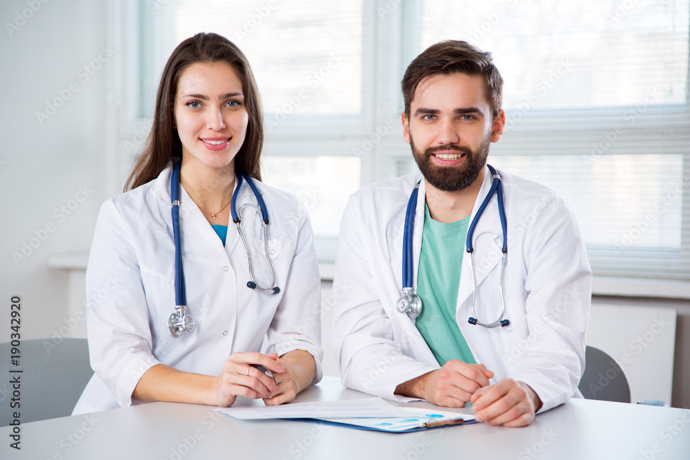 Group of doctors looking at camera and smiling Group of doctors looking at camera and smiling