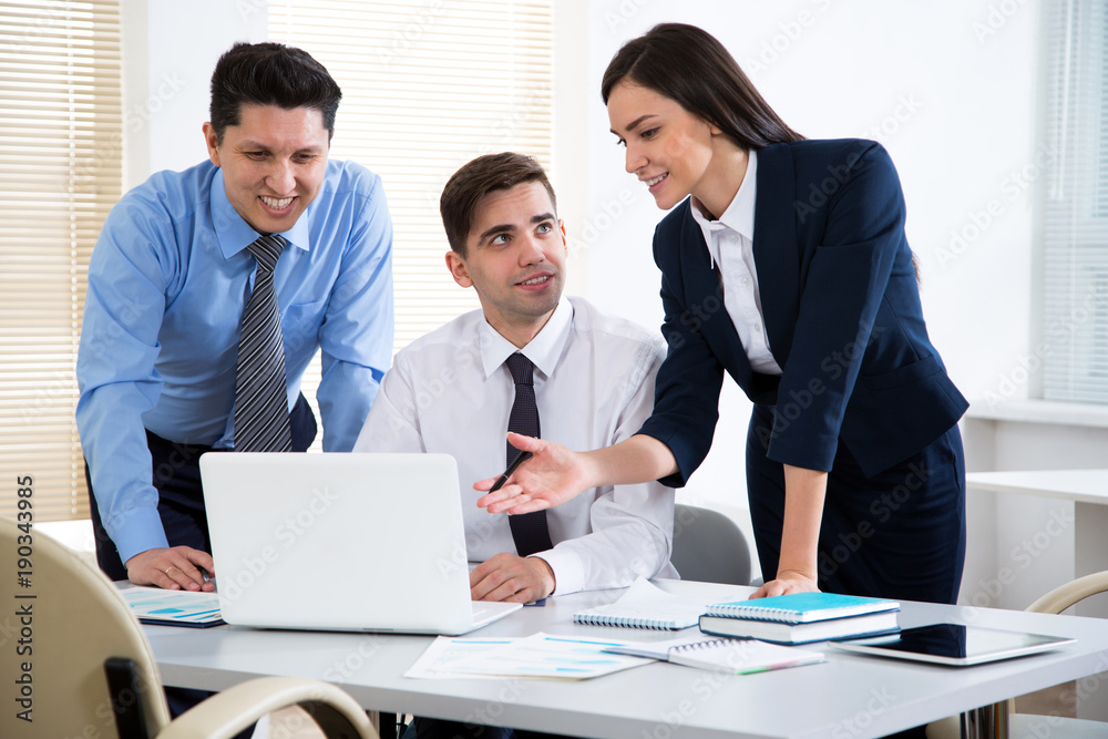 Businesswoman explains to businessmen a new project Businesswoman explains to businessmen a new project