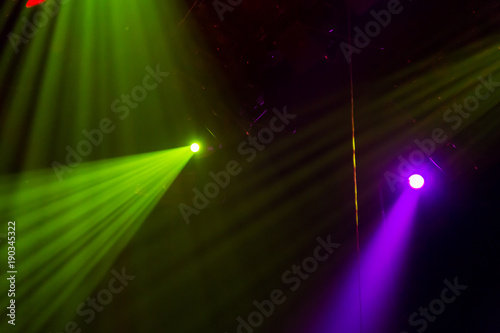 Lighting equipment on the stage of a theatre or concert hall. The rays of light from spotlights. Halogen and led light bulbs. Lens lighting