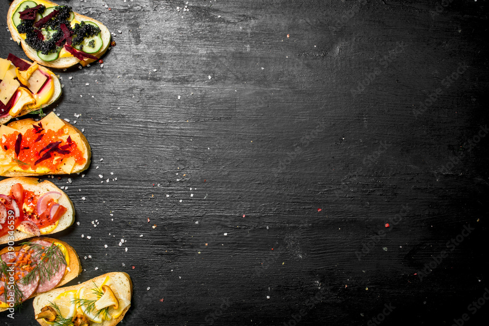 Fresh sandwiches from seafood with salmon, caviar, bacon and vegetables. Fresh sandwiches from seafood with salmon, caviar, bacon and vegetables.