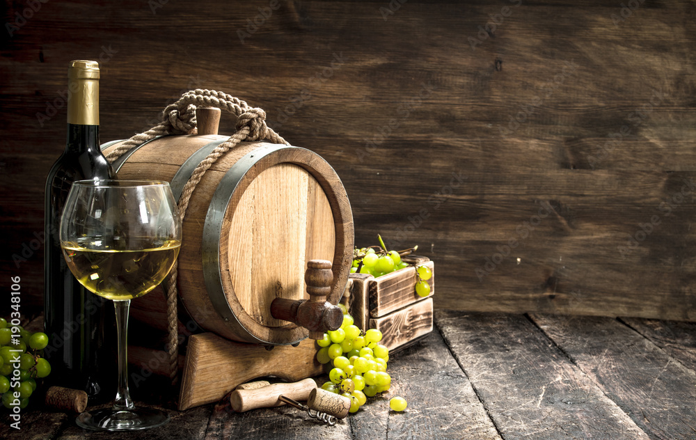 Wine background. A barrel of white wine with branches of green grapes.