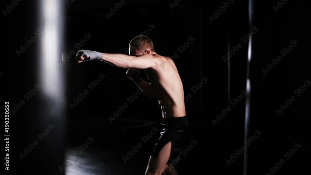 Young Man Punches In Boxing Gym. Shadow Boxing. Young Man Punches In Boxing Gym. Shadow Boxing.