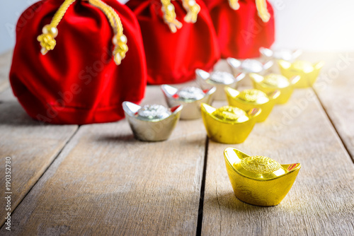 Chinese New Year Red fabric bag, ang pow with Chinese money of luck and Shoe-shaped gold ingot