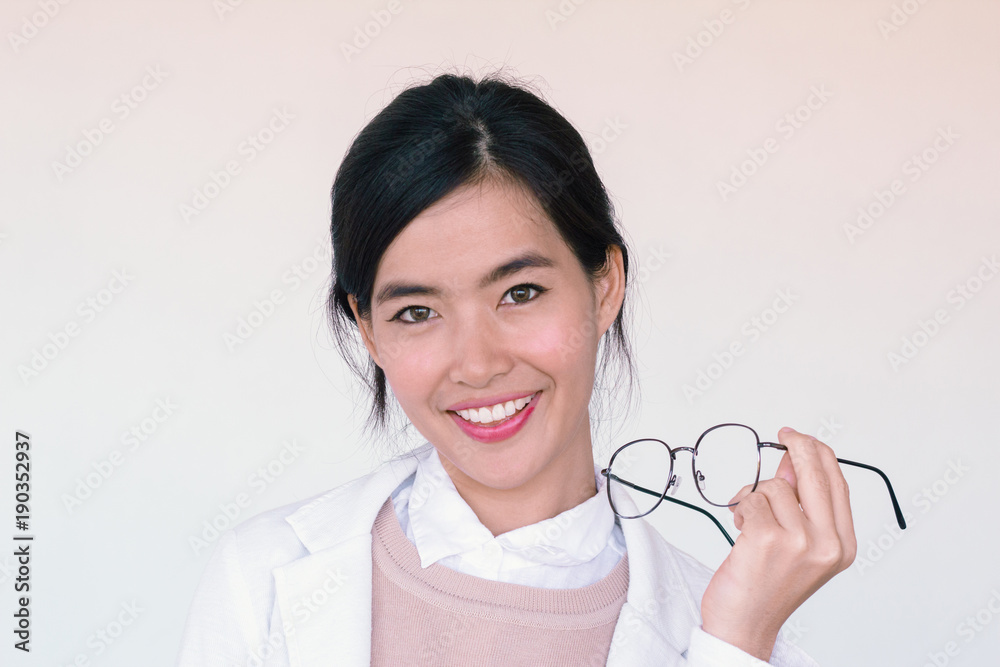 portrait head shot of young asian doctor holding glasses smiling portrait head shot of young asian doctor holding glasses smiling
