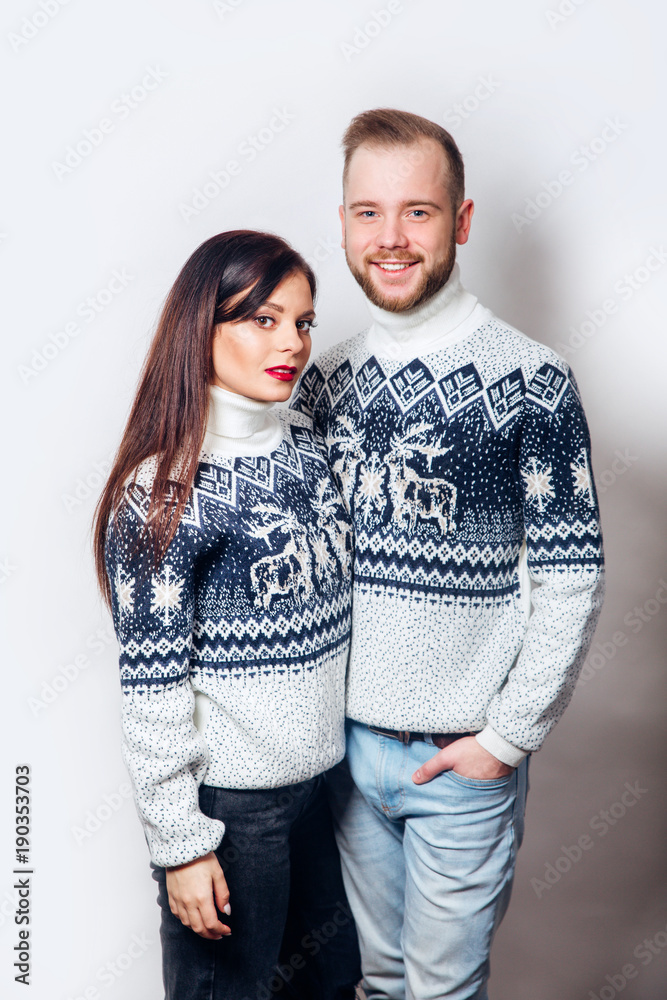 Attractive couple in winter fashion hugging Attractive couple in winter fashion hugging