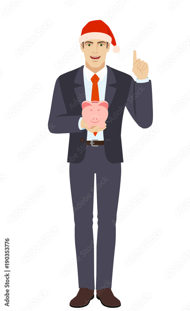 Businessman holding a piggy bank and pointing up