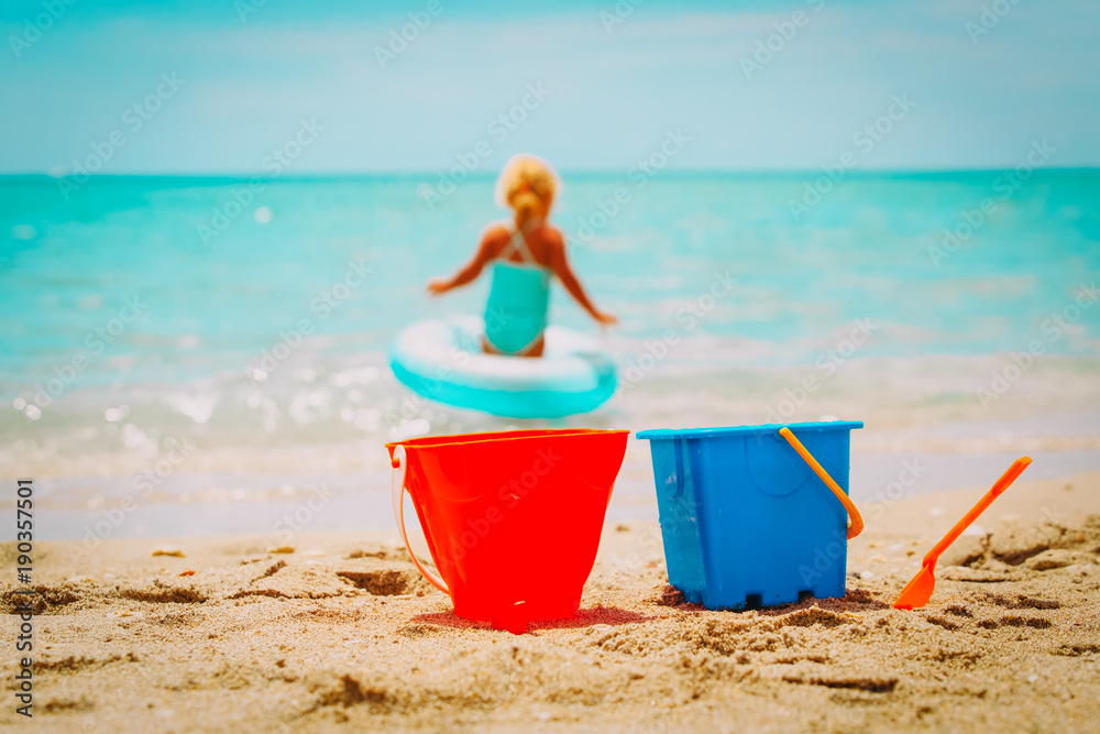 kids toys and little girl go swim at beach kids toys and little girl go swim at beach