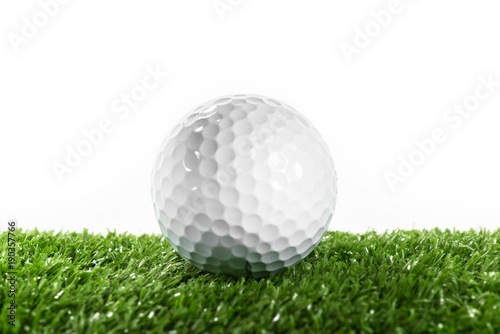 White golf ball on green lawn.