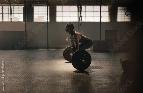 Vászonkép Fitness woman doing weightlifting exercise