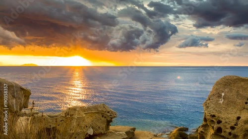 Day to night timelapse of stormy sunset from a beach on a Mediterranean island