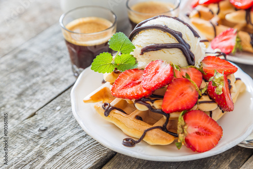 Waffles with strawberry, ice cream and chocolate
